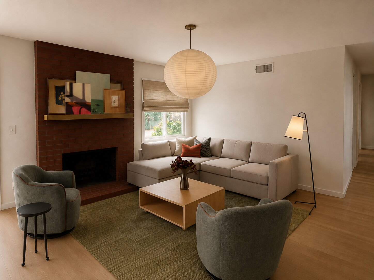 Warm living room with a brick fireplace, paper lantern pendant, and tailored seating